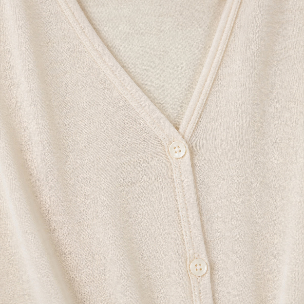Fine-knit cardigan texture and closure detail